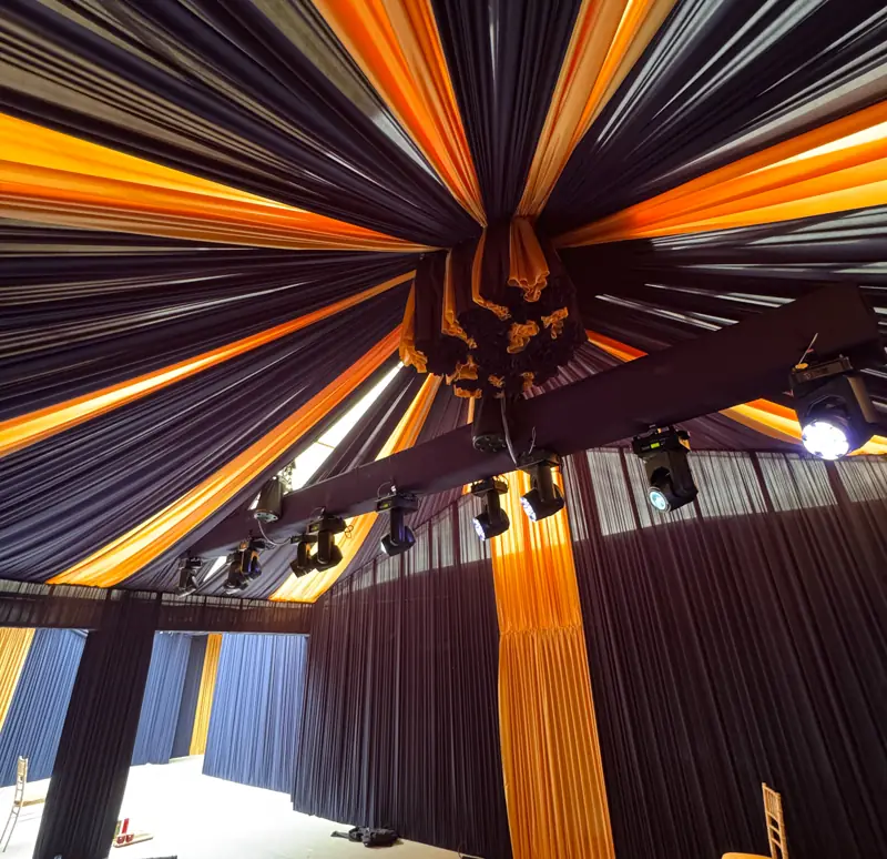Marquee ceiling with draping and warm light before guests arrive