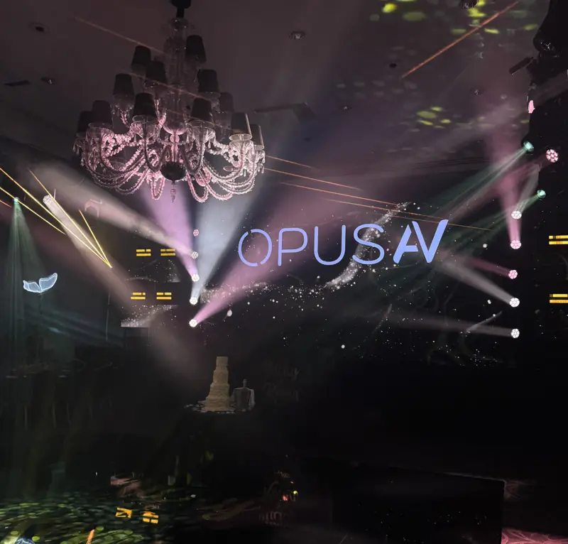 Ballroom with the Opus AV logo projected through beam lighting
