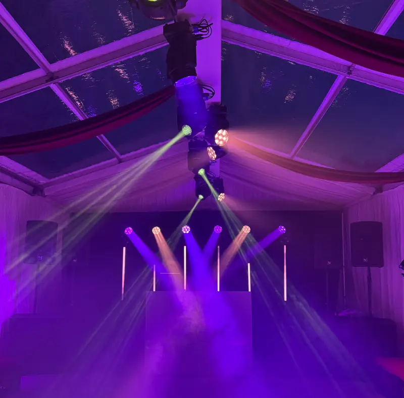 Purple beams crossing a marquee ceiling