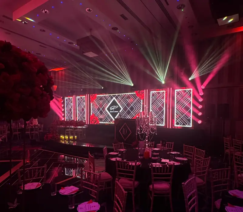 Monogram reception under red lighting and white beams