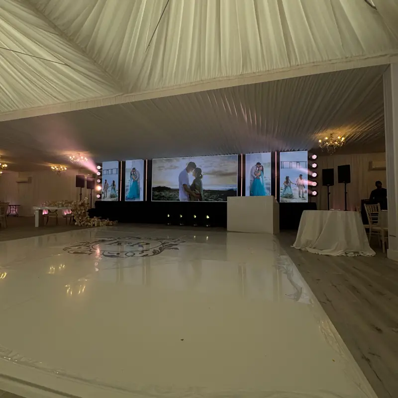 A softly lit marquee with a clear central aisle