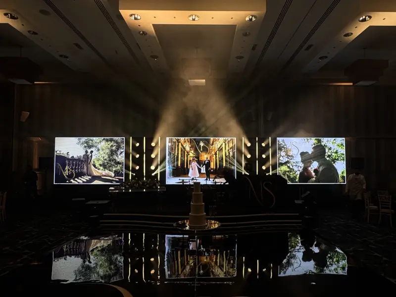 Reception room with three LED screens through haze